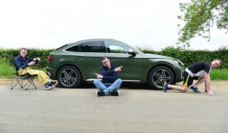 Auto Express associate editor Sean Carson striking various poses around the Audi SQ5